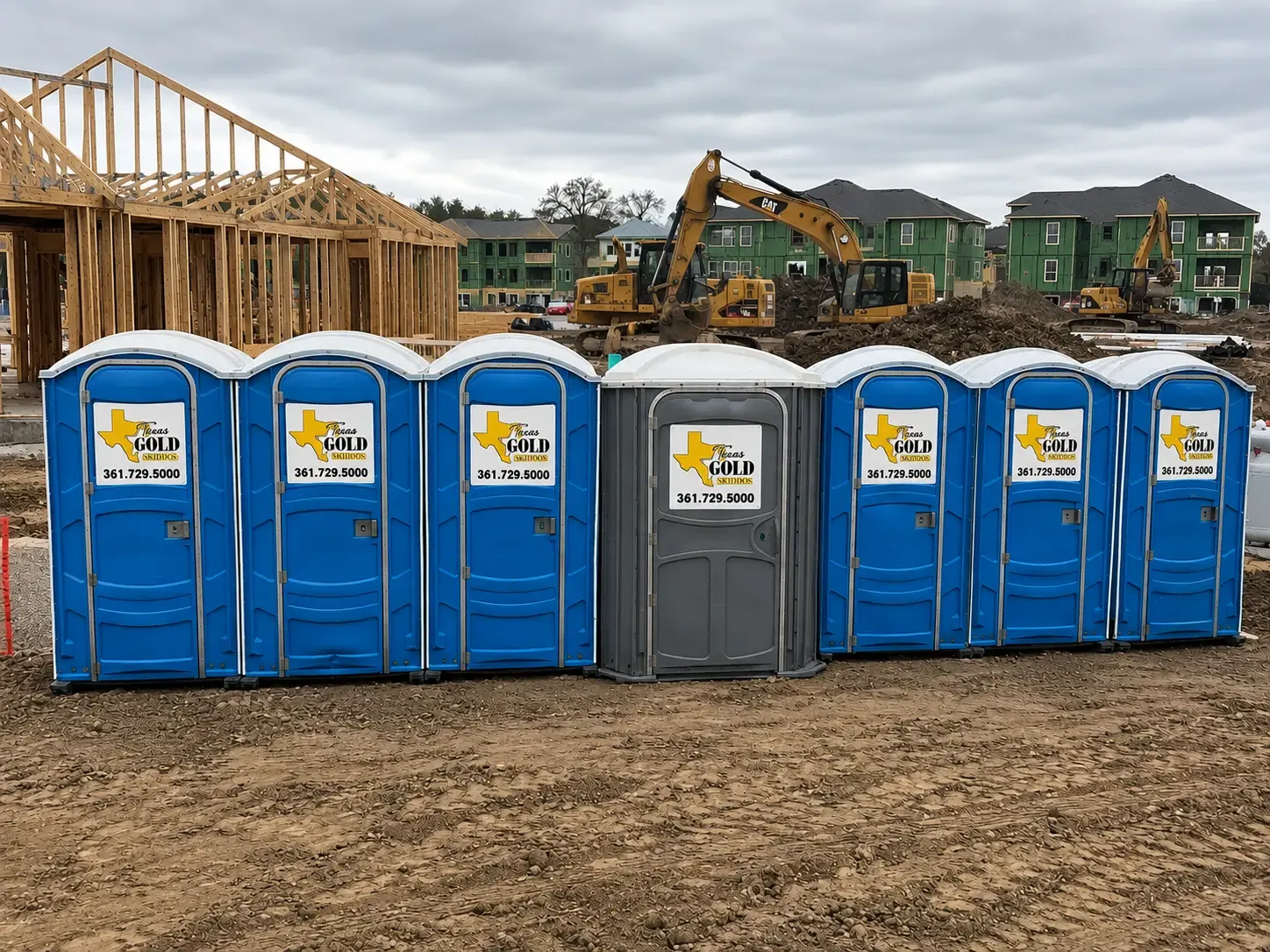 A1 Texas Gold porta potties staged at an active construction site